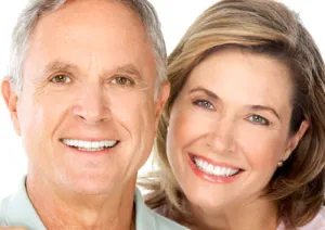 Smiling couple with all their teeth or, are they dental implants...